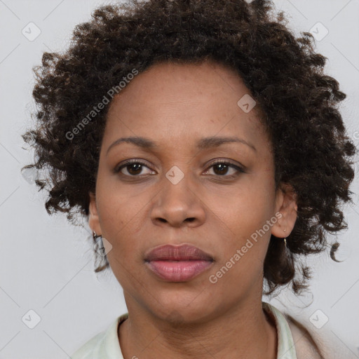 Joyful black adult female with medium  brown hair and brown eyes