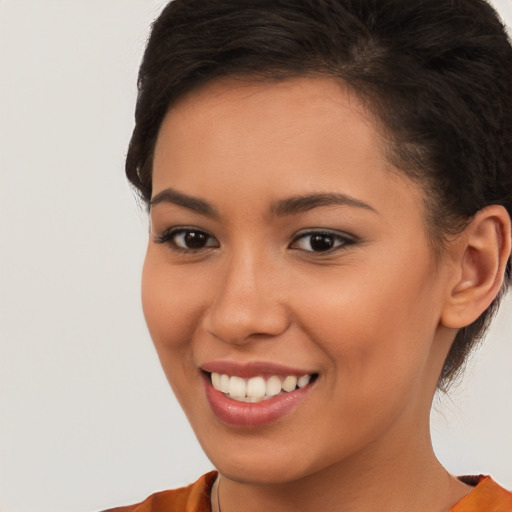 Joyful latino young-adult female with short  brown hair and brown eyes