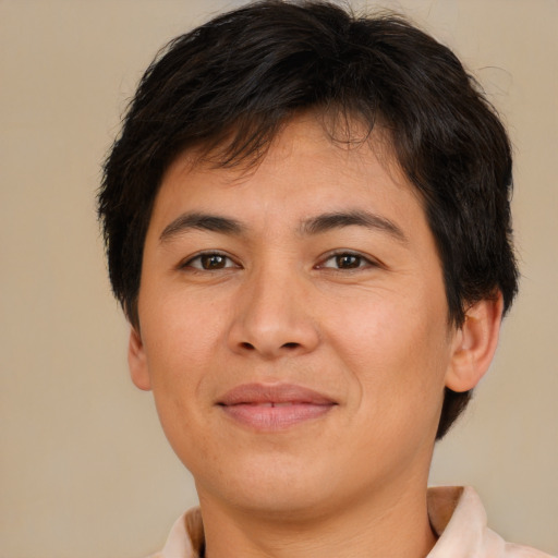 Joyful asian young-adult male with short  brown hair and brown eyes