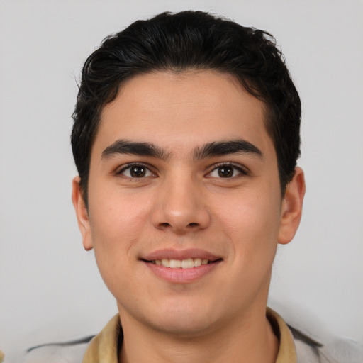 Joyful latino young-adult male with short  brown hair and brown eyes