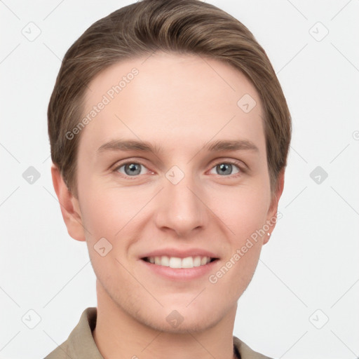 Joyful white young-adult male with short  brown hair and grey eyes