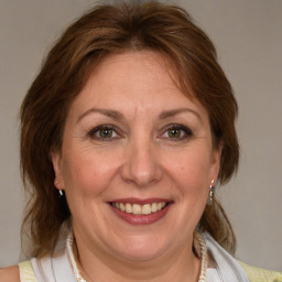 Joyful white adult female with medium  brown hair and blue eyes