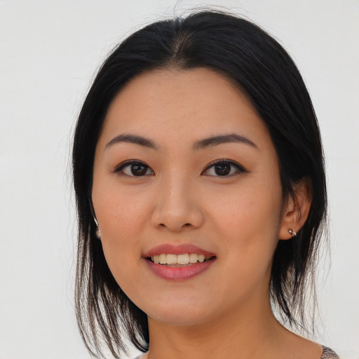 Joyful asian young-adult female with medium  black hair and brown eyes