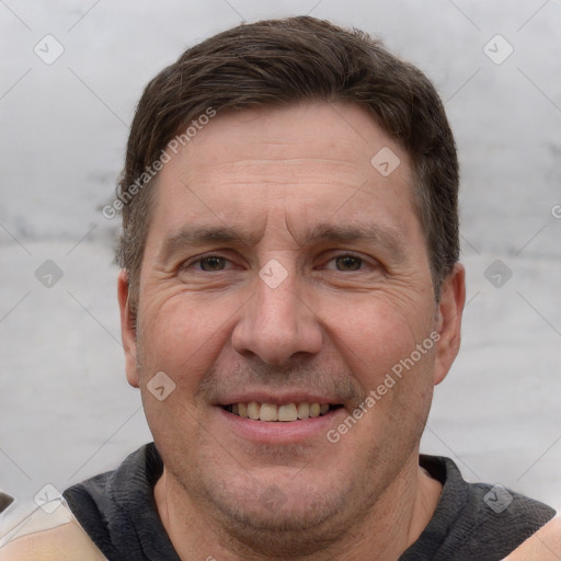 Joyful white adult male with short  brown hair and grey eyes