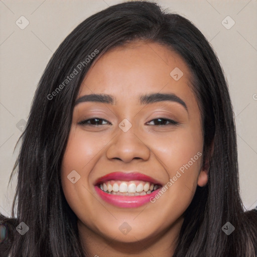 Joyful latino young-adult female with long  black hair and brown eyes