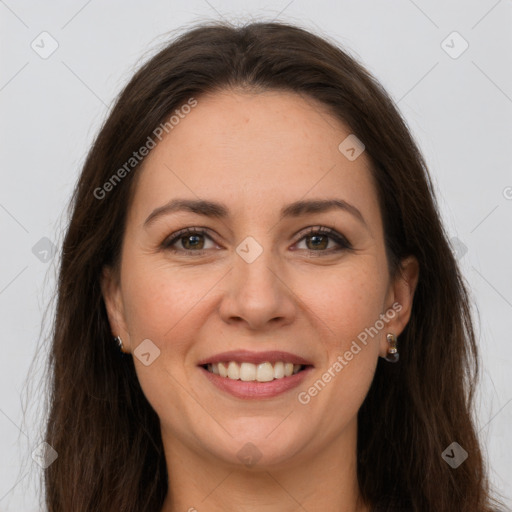 Joyful white adult female with long  brown hair and grey eyes