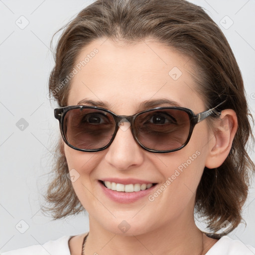 Joyful white young-adult female with medium  brown hair and blue eyes