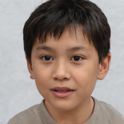 Joyful white child male with short  brown hair and brown eyes