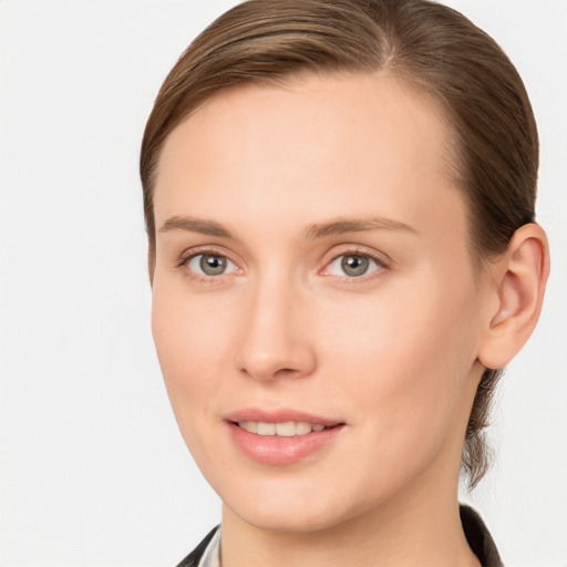 Joyful white young-adult female with long  brown hair and blue eyes