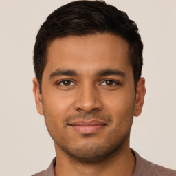 Joyful latino young-adult male with short  brown hair and brown eyes