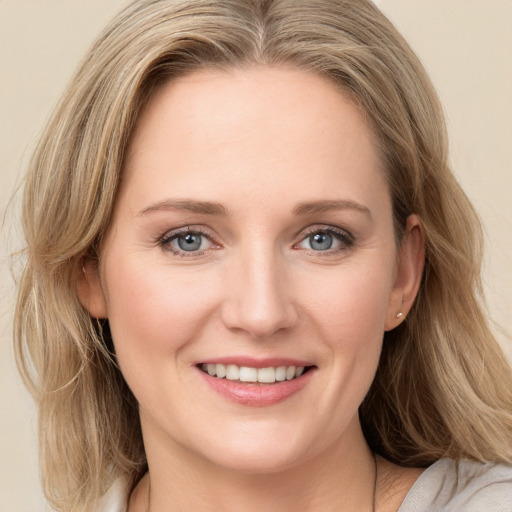 Joyful white young-adult female with medium  brown hair and blue eyes