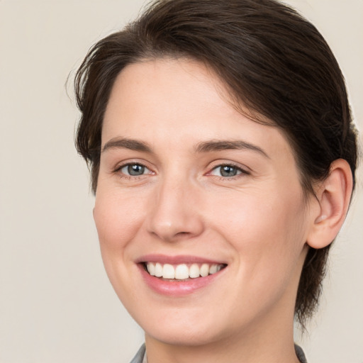 Joyful white young-adult female with medium  brown hair and brown eyes