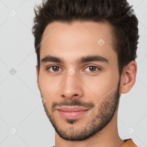 Joyful white young-adult male with short  brown hair and brown eyes