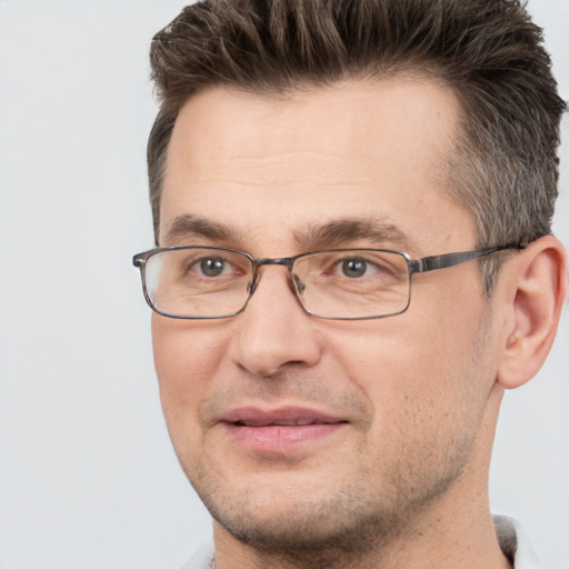 Joyful white adult male with short  brown hair and brown eyes