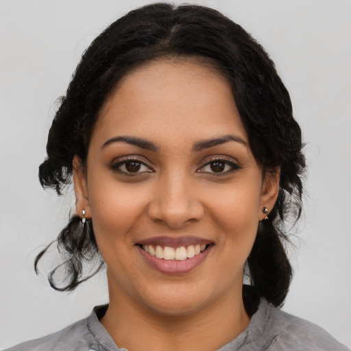 Joyful latino young-adult female with medium  black hair and brown eyes