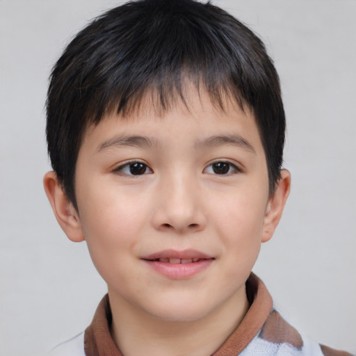 Joyful asian child male with short  brown hair and brown eyes