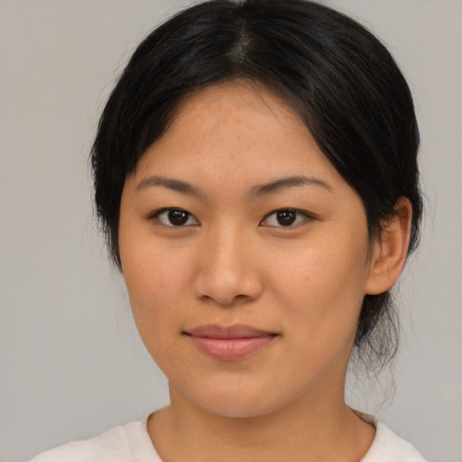 Joyful asian young-adult female with medium  brown hair and brown eyes
