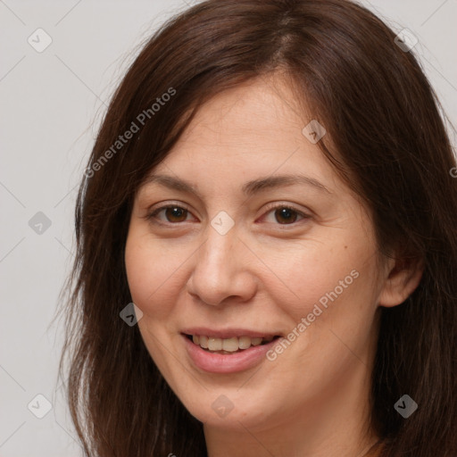 Joyful white adult female with long  brown hair and brown eyes