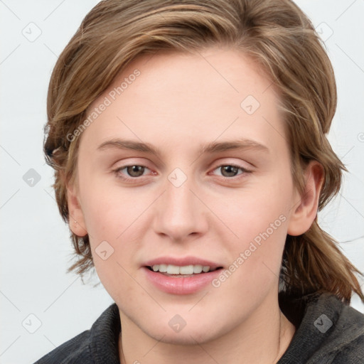 Joyful white young-adult female with medium  brown hair and blue eyes