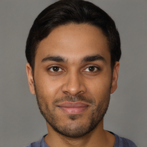 Joyful latino young-adult male with short  brown hair and brown eyes