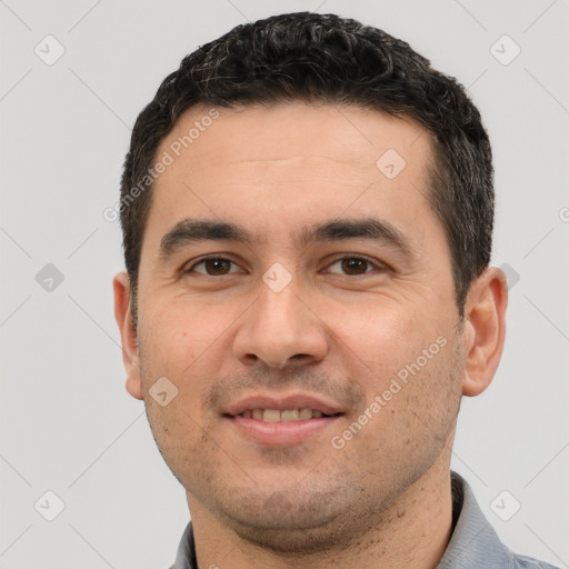 Joyful white young-adult male with short  black hair and brown eyes