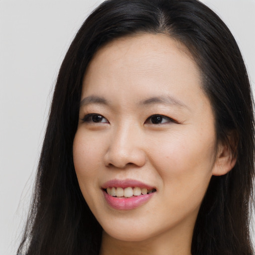 Joyful asian young-adult female with long  brown hair and brown eyes