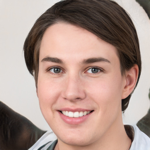 Joyful white young-adult female with medium  brown hair and grey eyes