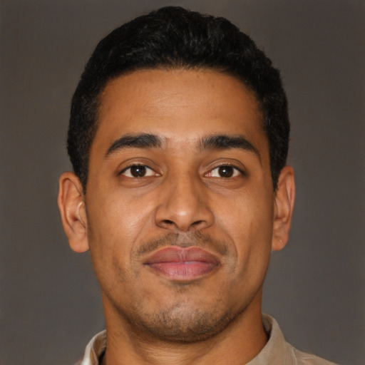 Joyful latino young-adult male with short  brown hair and brown eyes