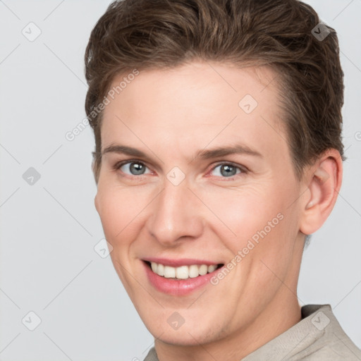 Joyful white young-adult female with short  brown hair and grey eyes