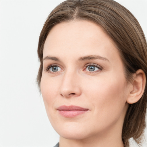 Joyful white young-adult female with medium  brown hair and grey eyes