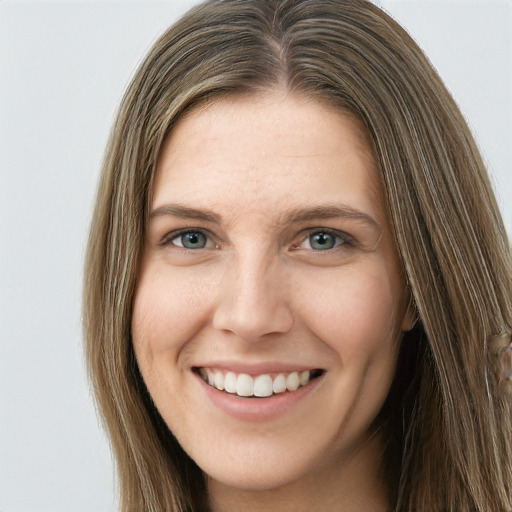 Joyful white young-adult female with long  brown hair and green eyes