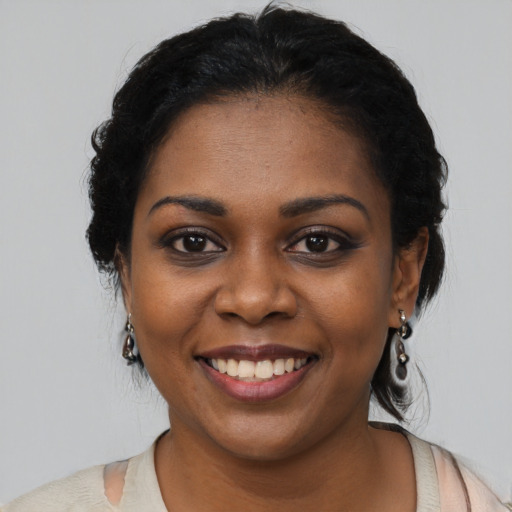 Joyful black young-adult female with medium  black hair and brown eyes