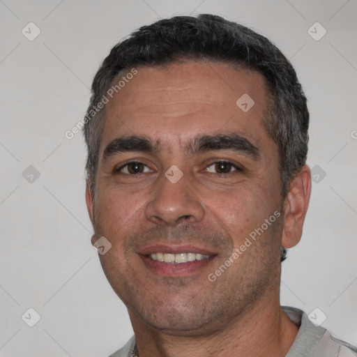 Joyful white adult male with short  black hair and brown eyes