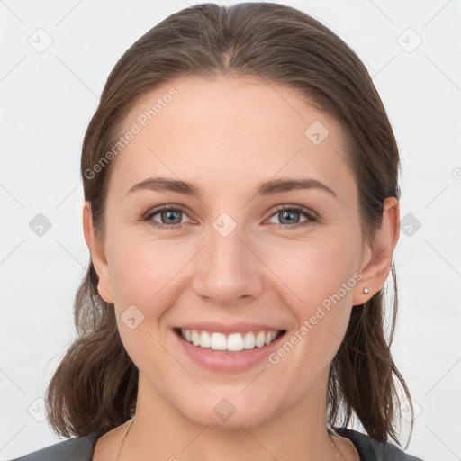 Joyful white young-adult female with medium  brown hair and grey eyes