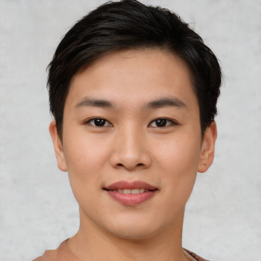 Joyful asian young-adult female with short  brown hair and brown eyes