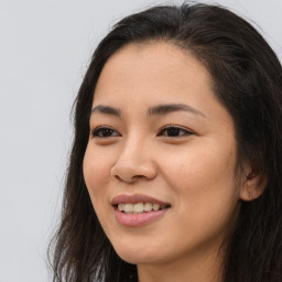 Joyful asian young-adult female with long  brown hair and brown eyes