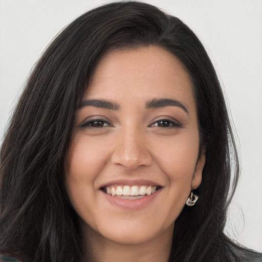 Joyful latino young-adult female with long  brown hair and brown eyes