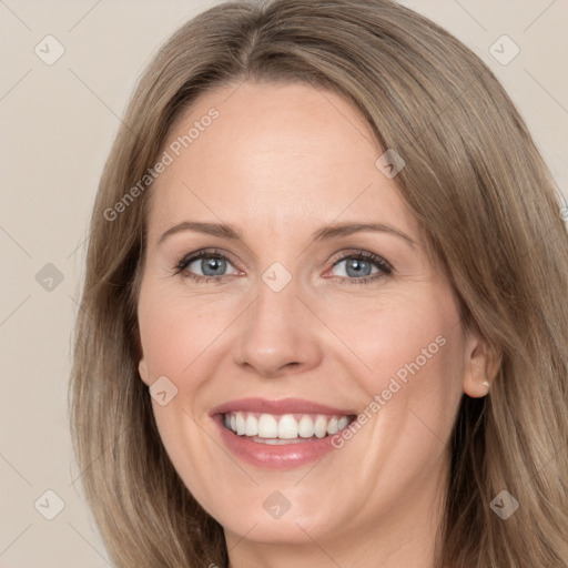 Joyful white adult female with long  brown hair and grey eyes