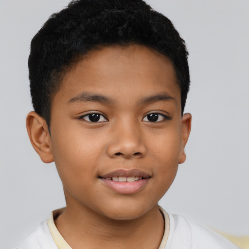 Joyful latino child male with short  brown hair and brown eyes