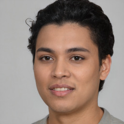 Joyful latino young-adult male with short  black hair and brown eyes