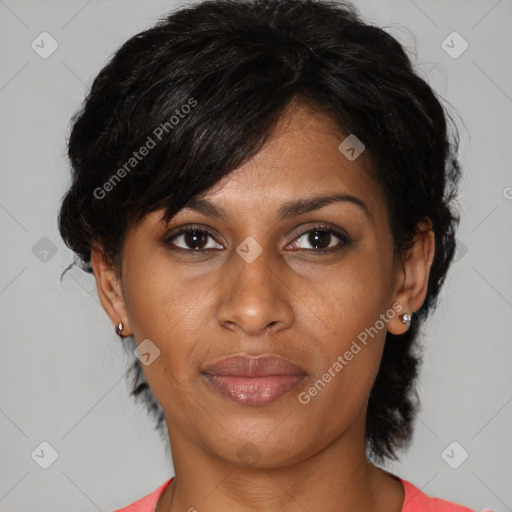 Joyful black adult female with medium  brown hair and brown eyes