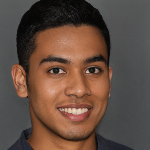 Joyful latino young-adult male with short  brown hair and brown eyes