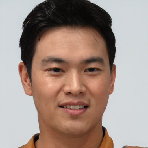 Joyful asian young-adult male with short  black hair and brown eyes