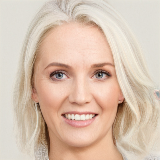 Joyful white young-adult female with medium  blond hair and blue eyes