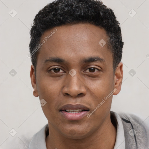Joyful black young-adult male with short  black hair and brown eyes