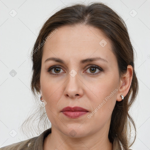 Joyful white adult female with medium  brown hair and grey eyes