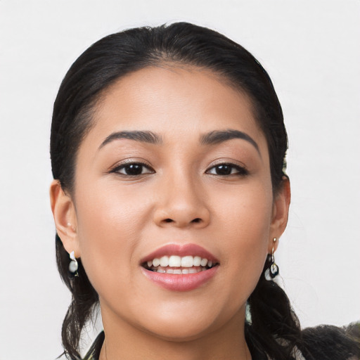 Joyful latino young-adult female with medium  black hair and brown eyes