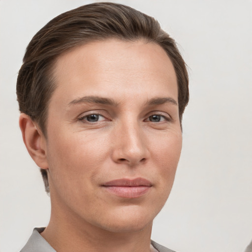 Joyful white young-adult female with short  brown hair and grey eyes