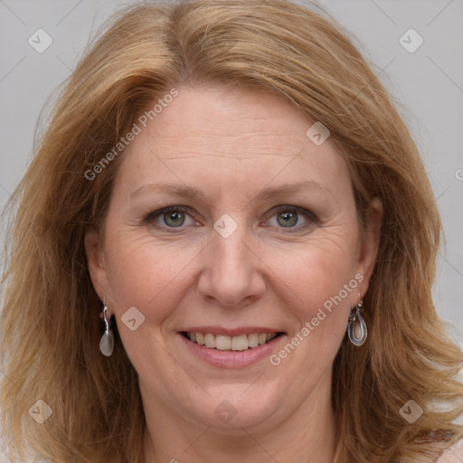 Joyful white adult female with long  brown hair and brown eyes