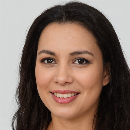Joyful asian young-adult female with long  brown hair and brown eyes